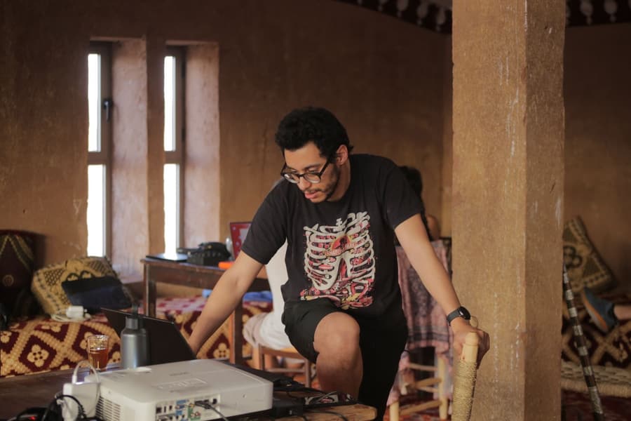 Disektor setting up a laptop and projector for the sound design workshop at LPM 2025